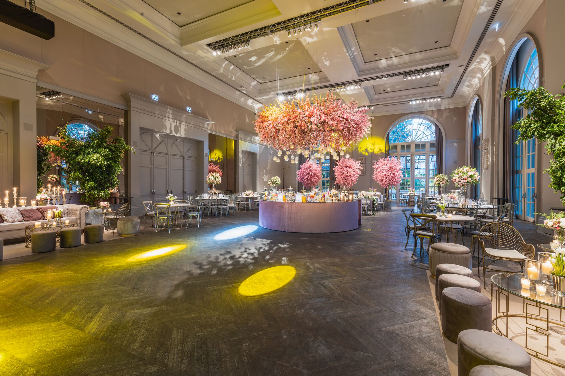 Elegant wedding reception in a luxurious hall with stunning flower arrangements and ambient lighting. — Architrave Styles Tha