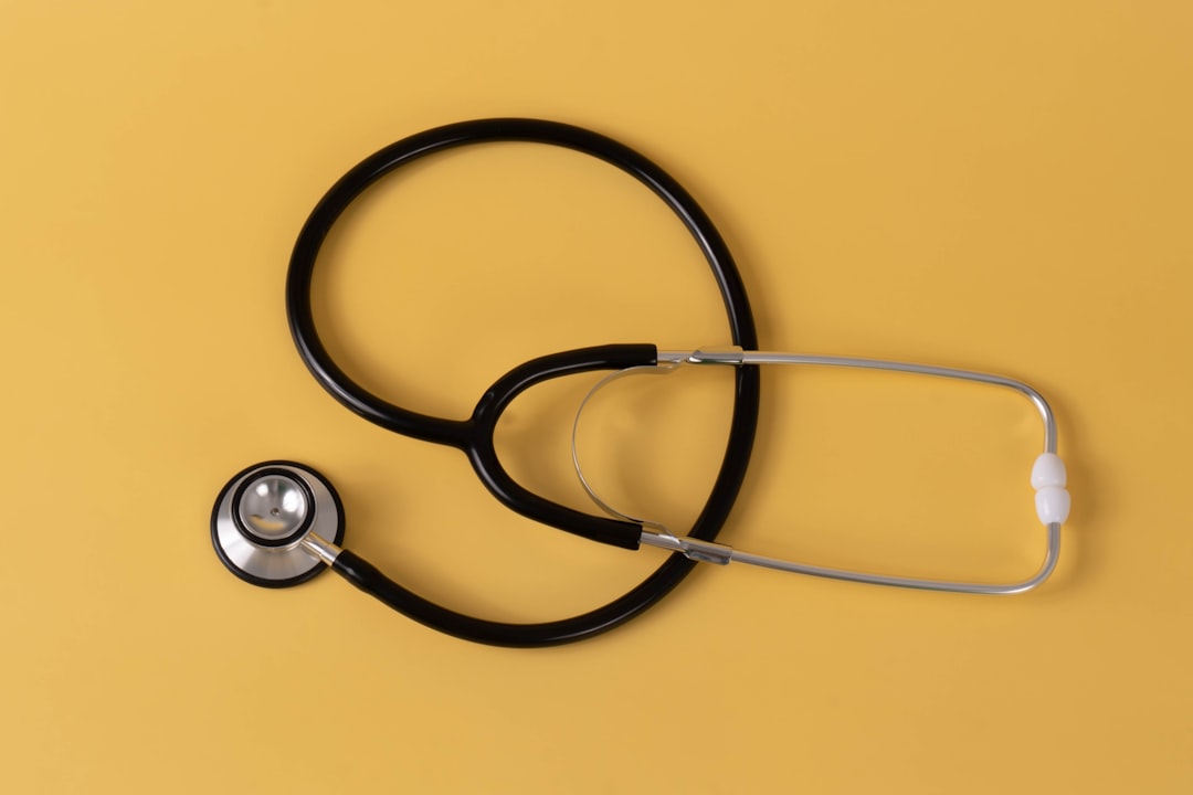 A stethoscope on a yellow background, representing healthcare.
